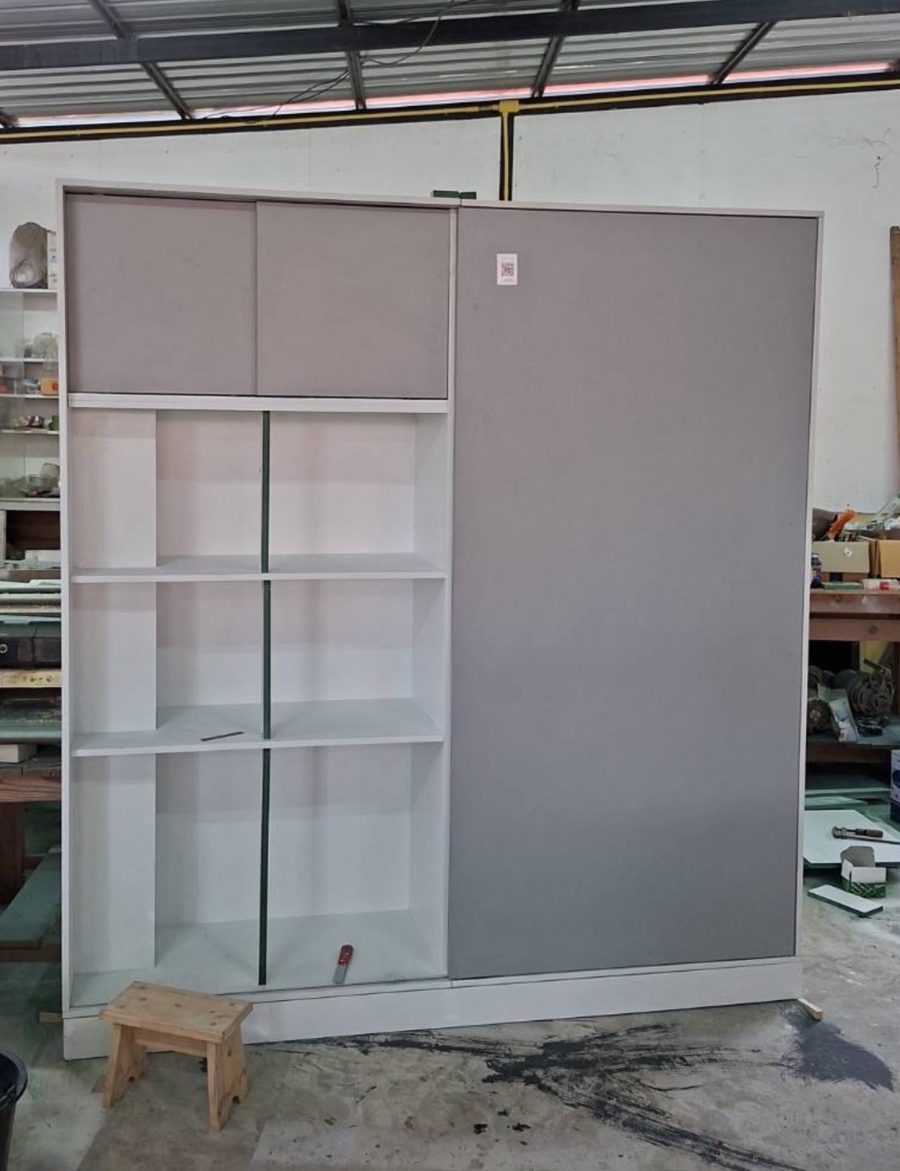 Finished sliding wardrobe with grey doors, top cabinets and open shelves in our workshop before delivery to Baan Suan Lalana