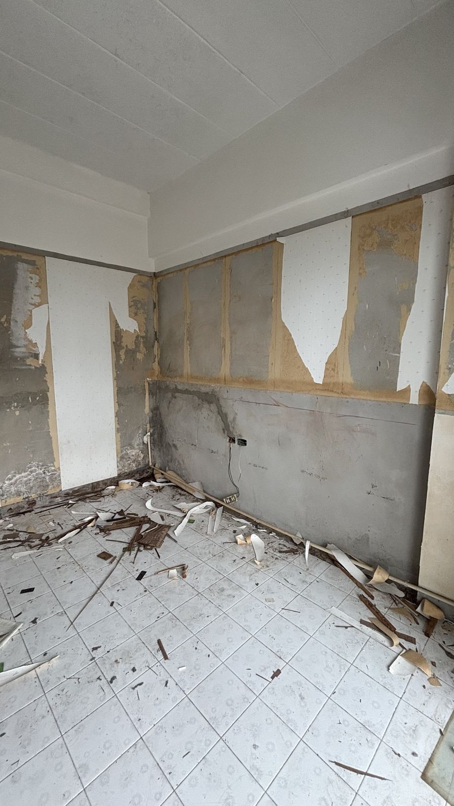 Before: old wallpaper stripped from the walls of a Chain Condominium studio, unit 813, Jomtien