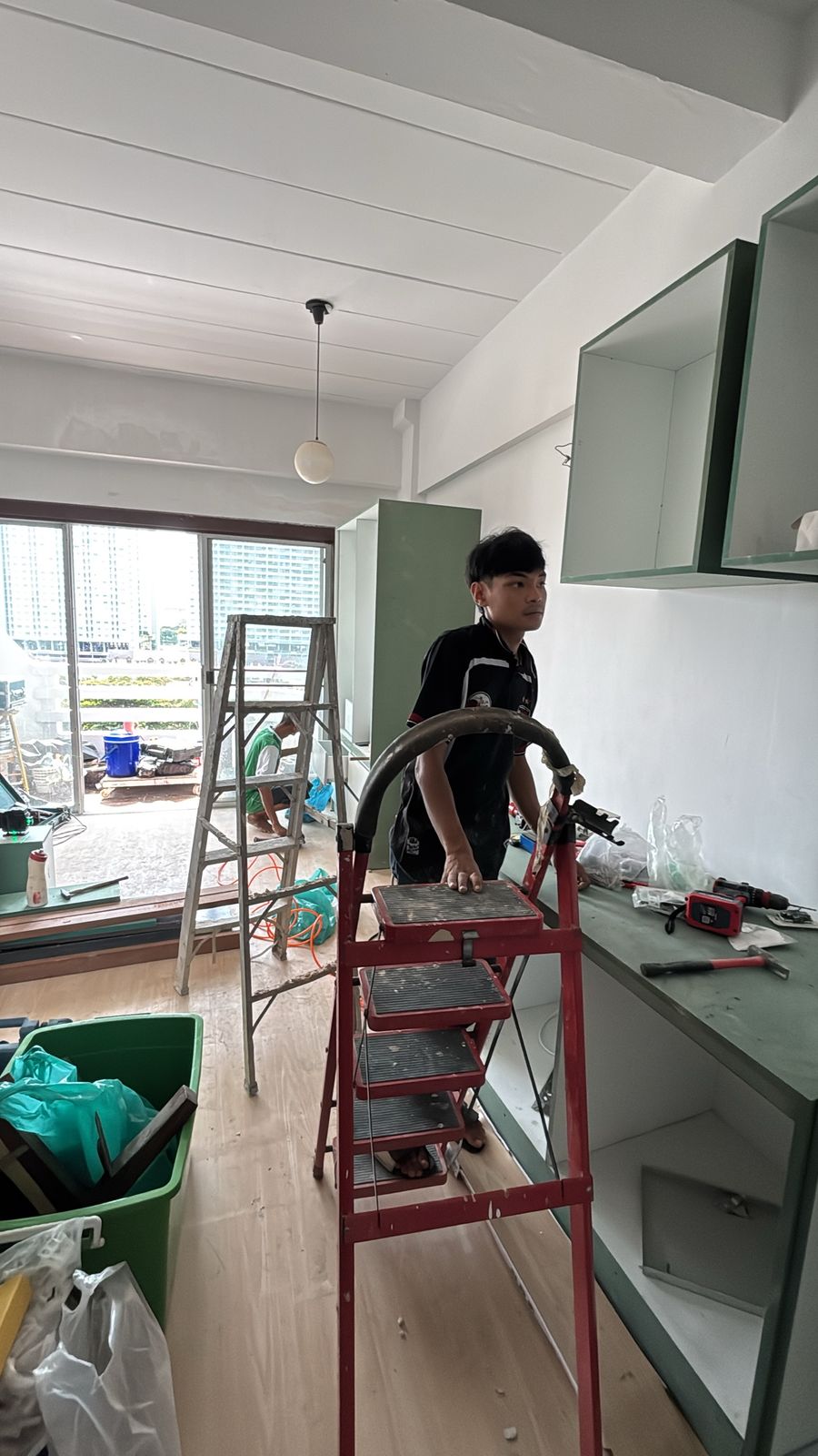 Installing built-in kitchen wall cabinets and counter at Chain Condominium, unit 813, Jomtien