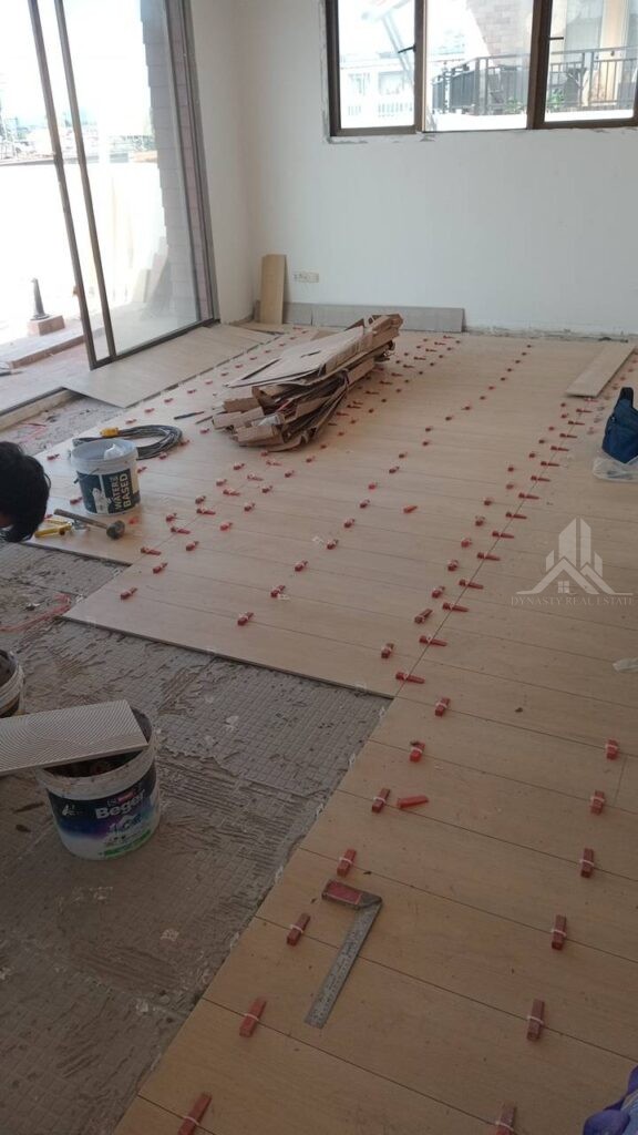 Wood-look floor tiles laid with levelling clips at Sunrise Condo, Pattaya